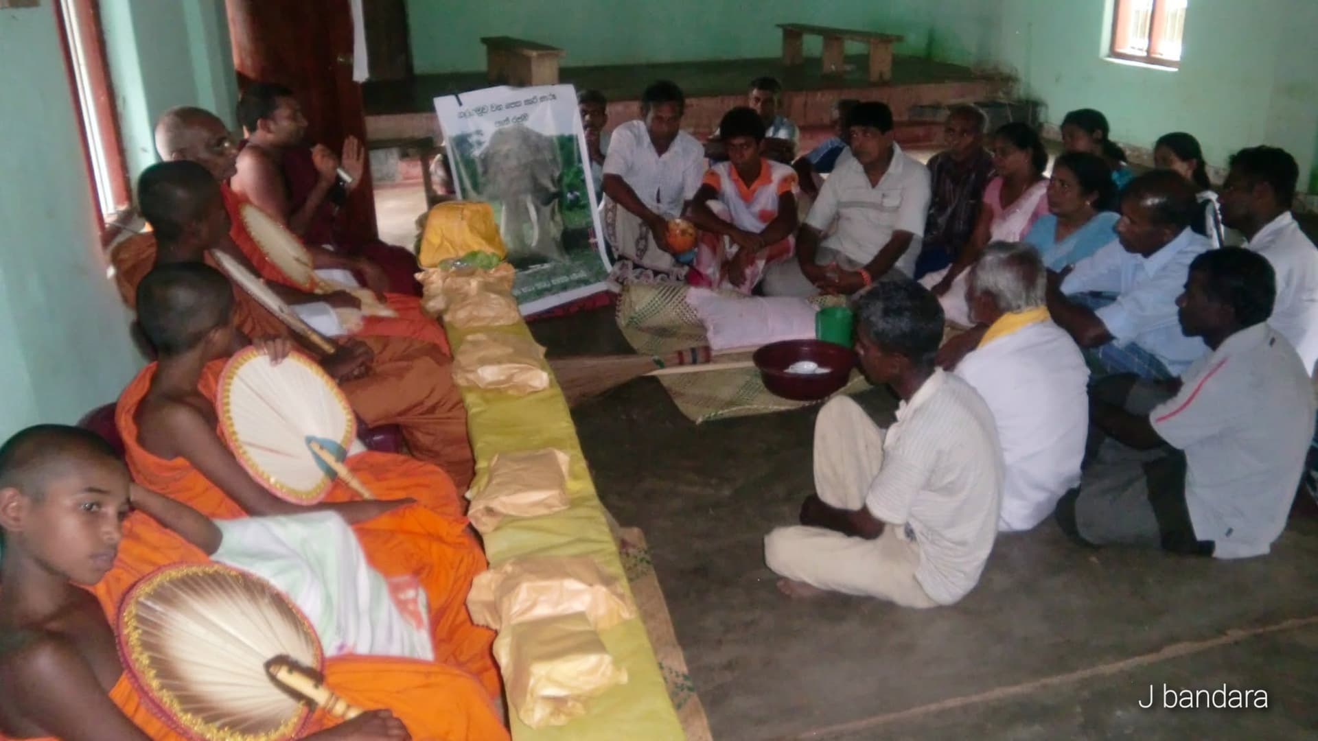 Buddhist monks and villagers performing religious rituals and almsgiving on 29 November 2010
